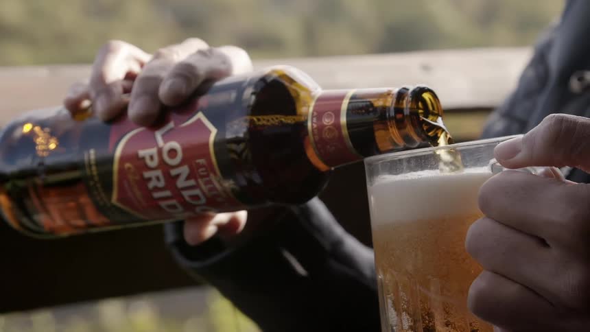A man pouring beer into a mug