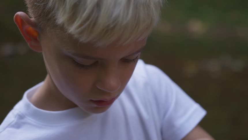 A boy is outdoors during day time