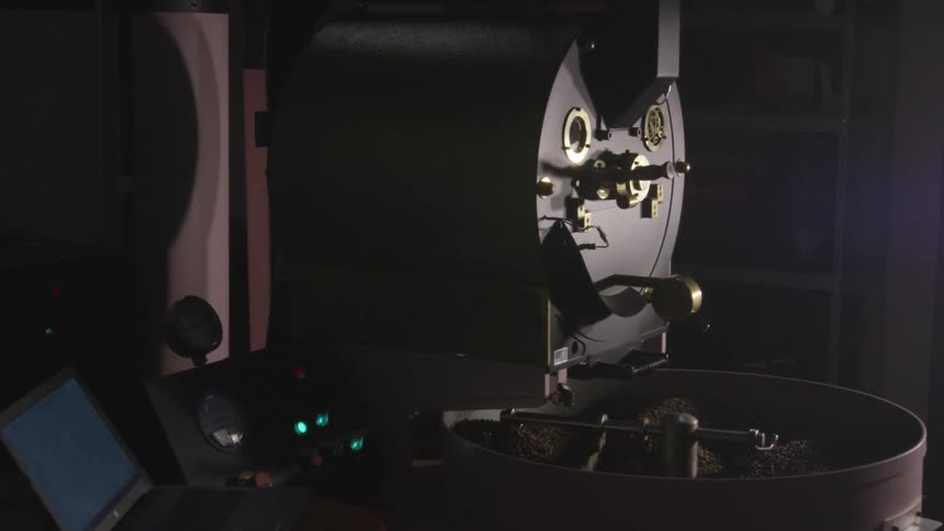 A roaster spinning coffee beans