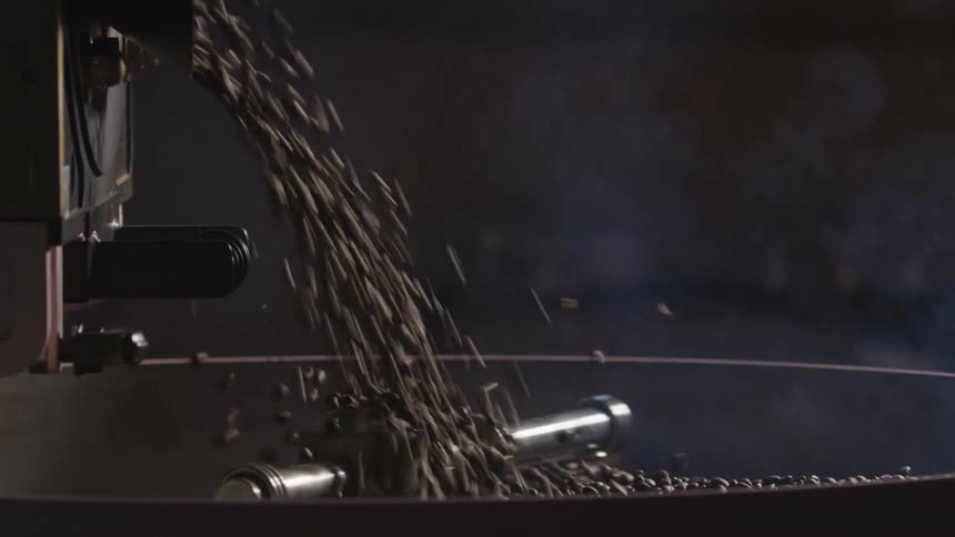 Beans rain down into a grinder