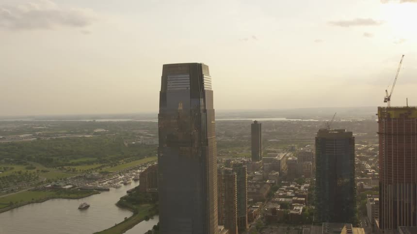 Skyscrapers stand in a city at sunset