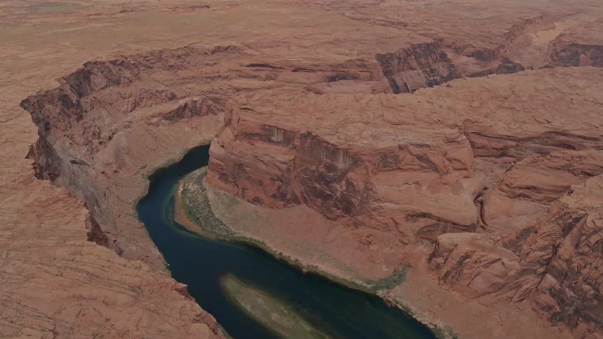Stream cuts through arid cliffs