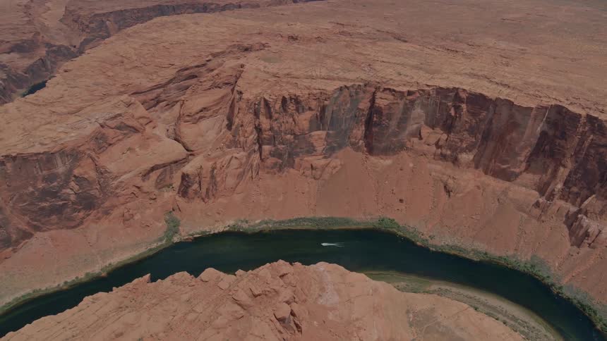 Red rocks and gorges with a boat traveling down the river
