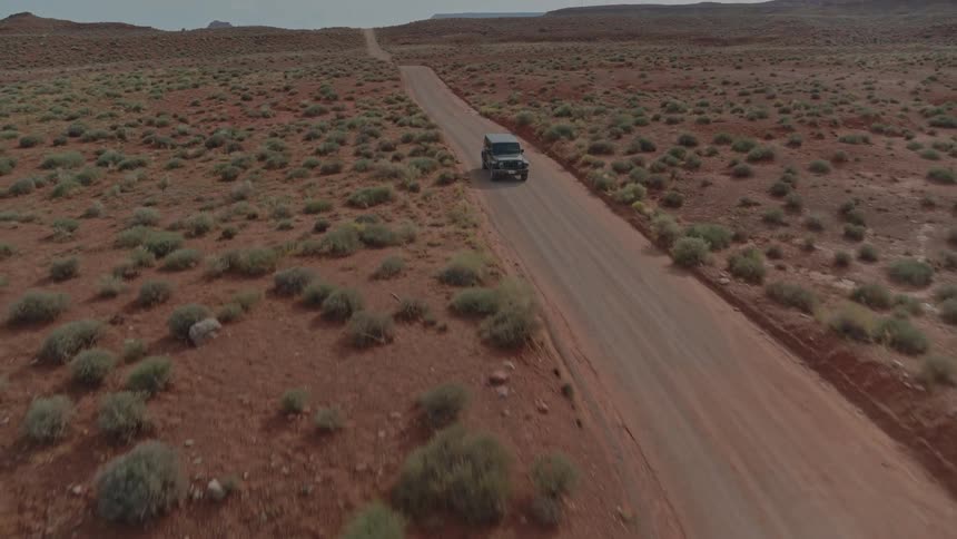 A car driving along a desert road