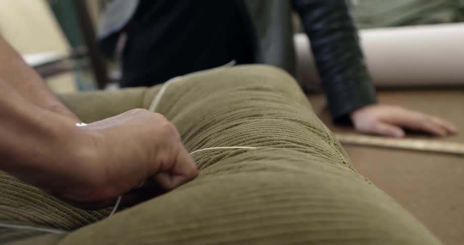 A person tying up a bundle