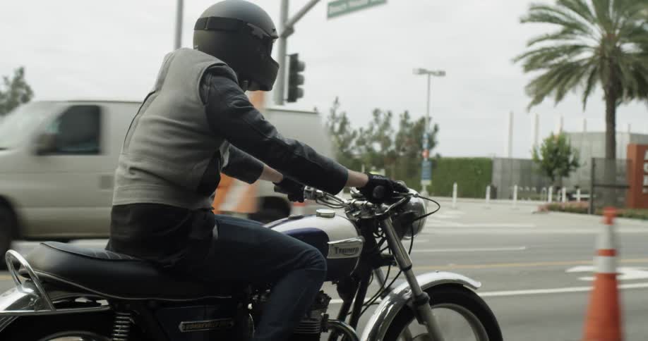 A man riding a motorcycle on a city street