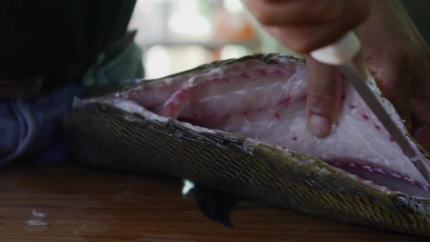 A man guts a fish