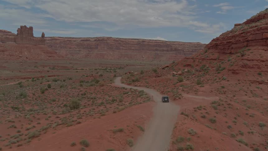 A car is driving in a remote area