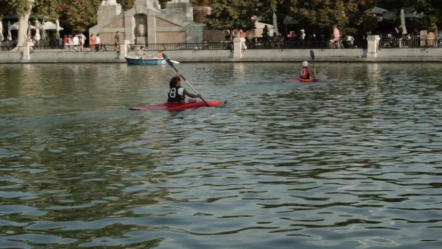People kayak and boat on a lake