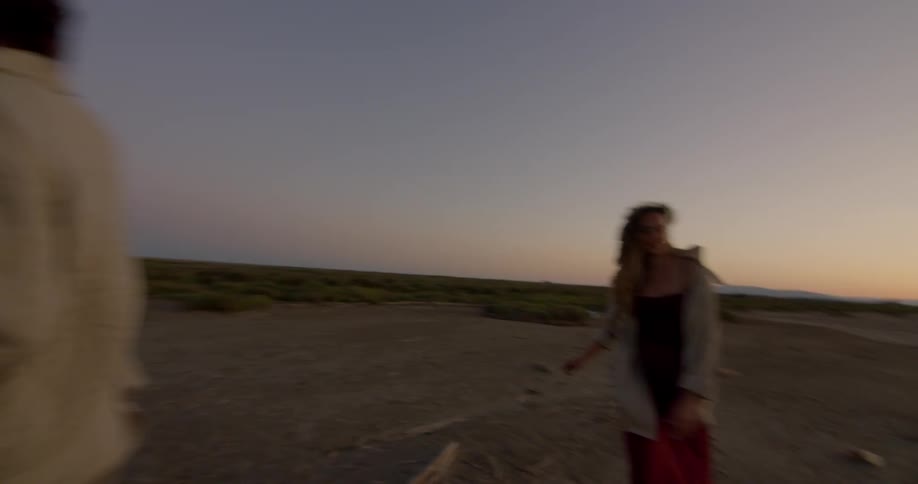 People are outside in a remote area at sunset