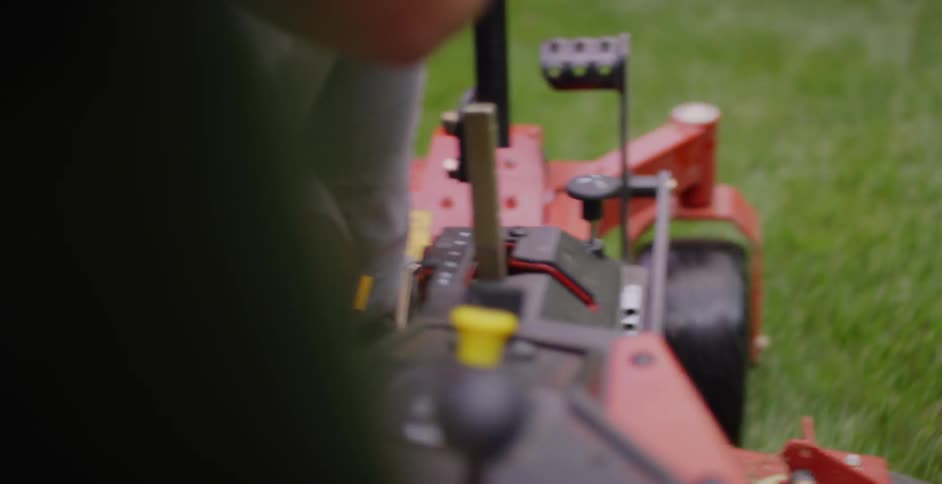 A man operating a powered lawn mower