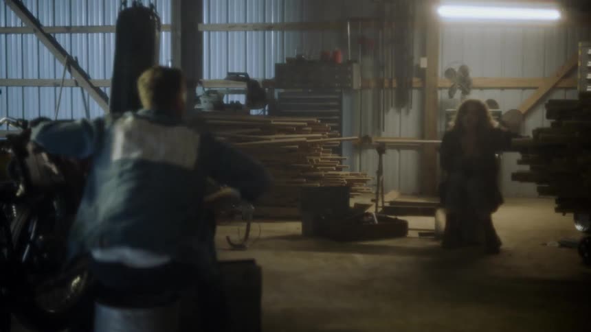 A man working on a motorcycle while lights flash