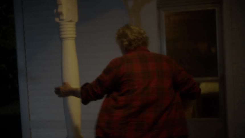 A man running off a front porch