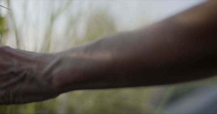 Man feeling the grass with his hands