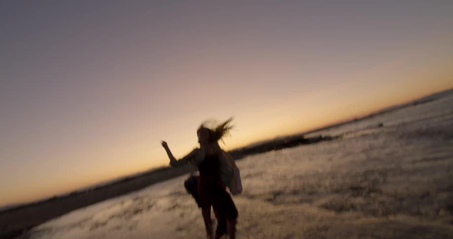Three people are outdoors by the beach
