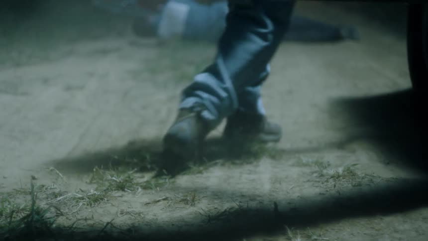 A man climbs out of a parked car and falls to his knees next to a body on the road