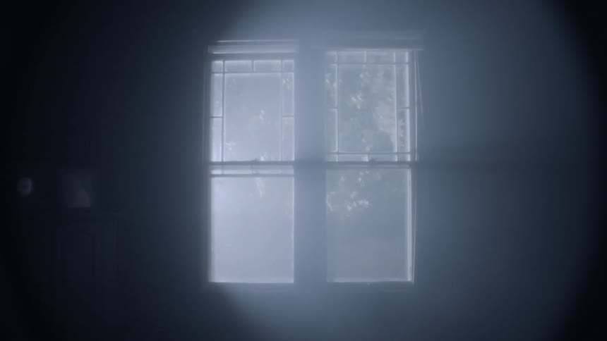 Light shining through window in dark room