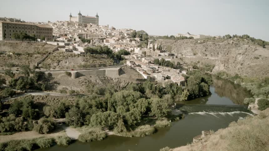 The river runs past the town on the hill