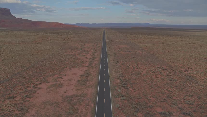 An empty road with fields on either side