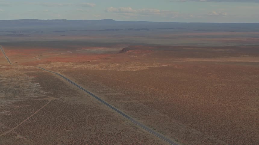 A car driving down a road in the desert