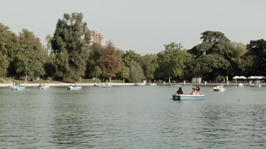 A family on a boat row at the lake