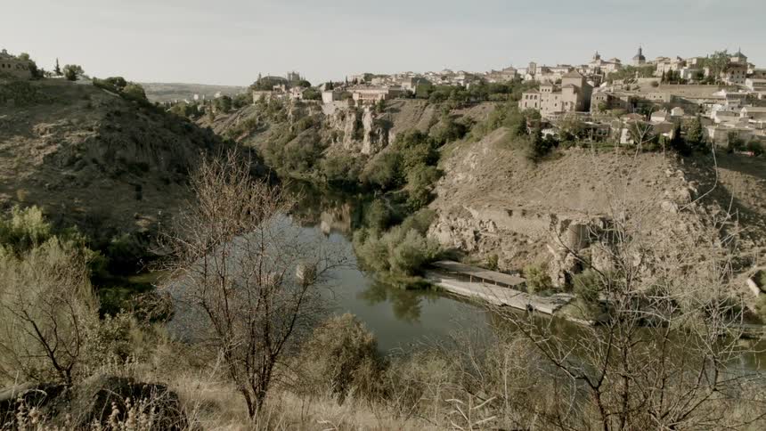 A village surrounded by a small waterway and trees