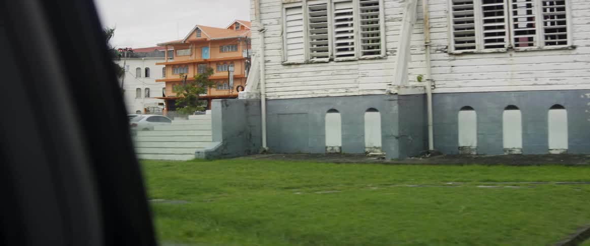 The lawns are green by the old houses