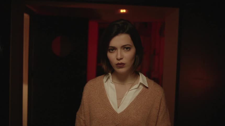 A woman is walking down the hall