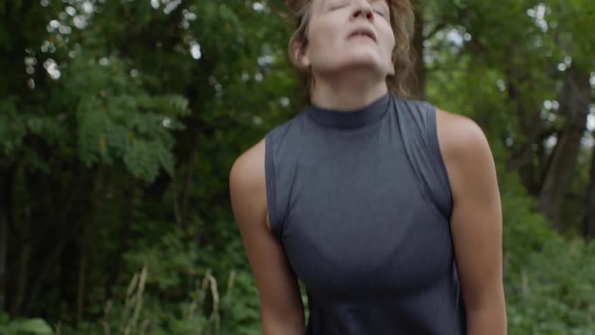 A female jogger resting in a wood
