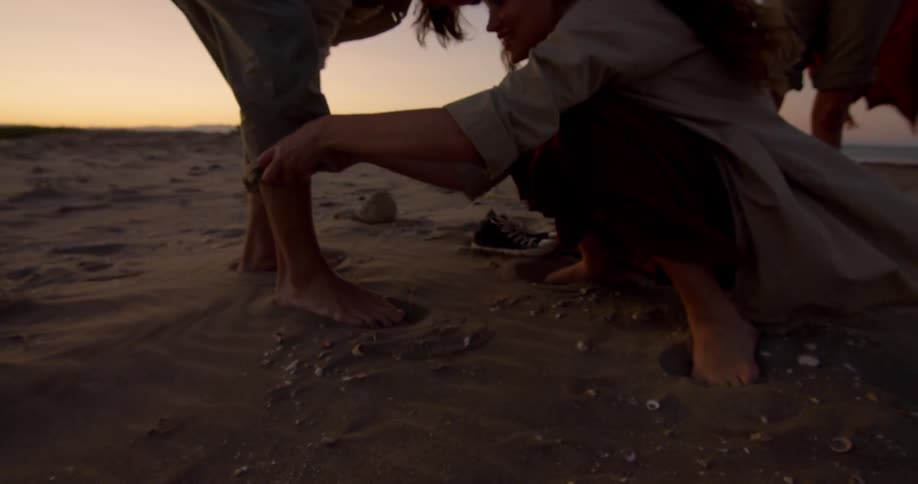 People are outdoors during sunset
