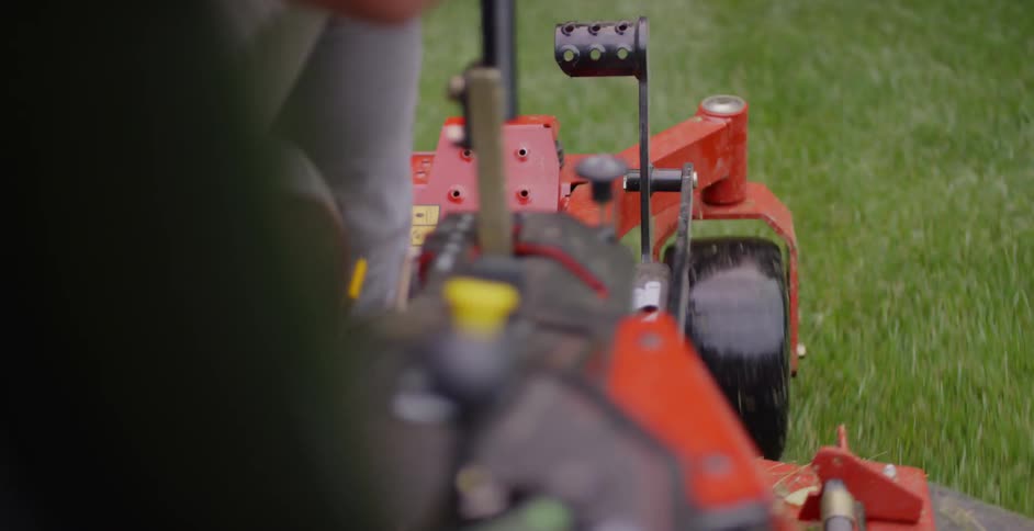 The mower is moving around the yard
