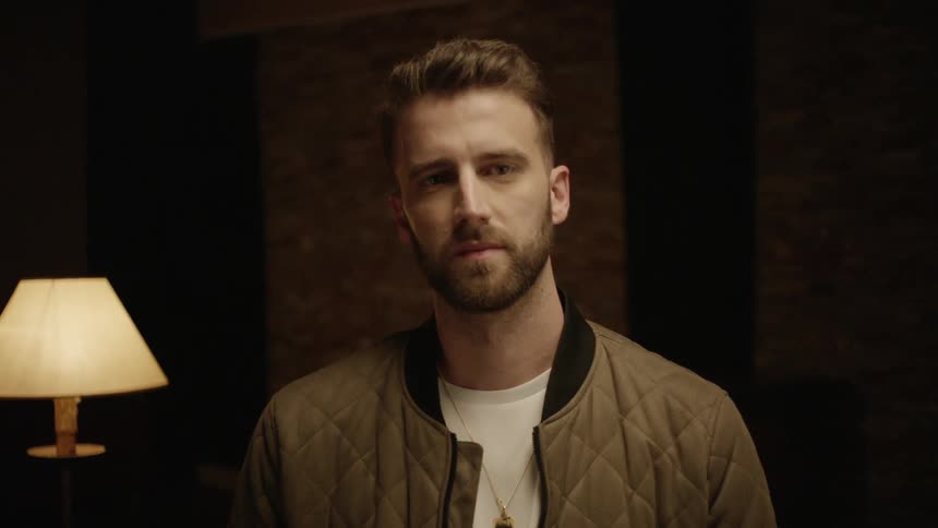 A man is in a room and standing