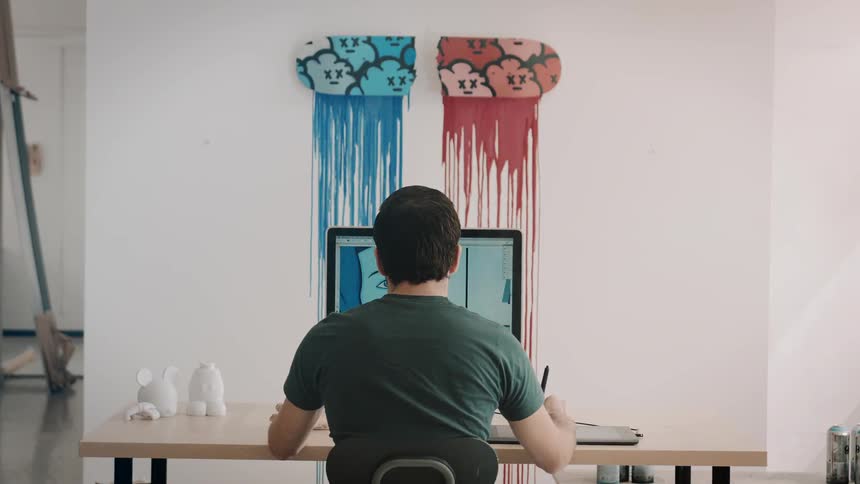 A man sits down using a computer in his home