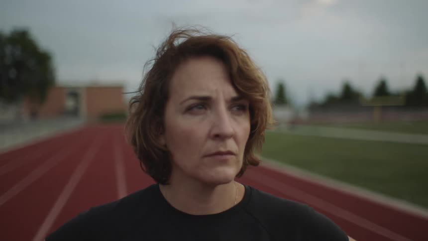 A woman standing on track looking ahead