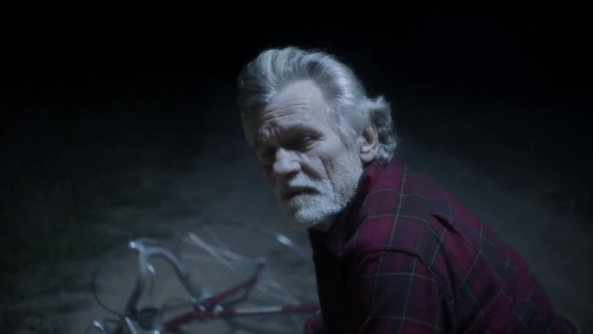 A man is crouching over another on the trail