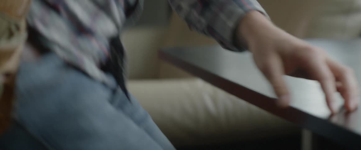A person picking up their bag and keys