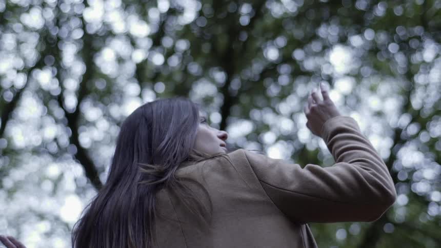 A woman looking around and turning on herself
