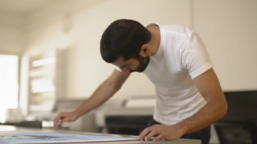 A man measuring something on a table