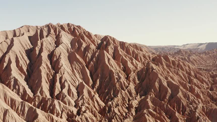 Red rocked mountains against a partly cloudy sky
