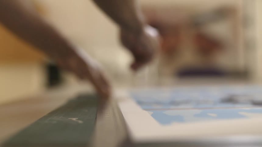 A man is working on artwork