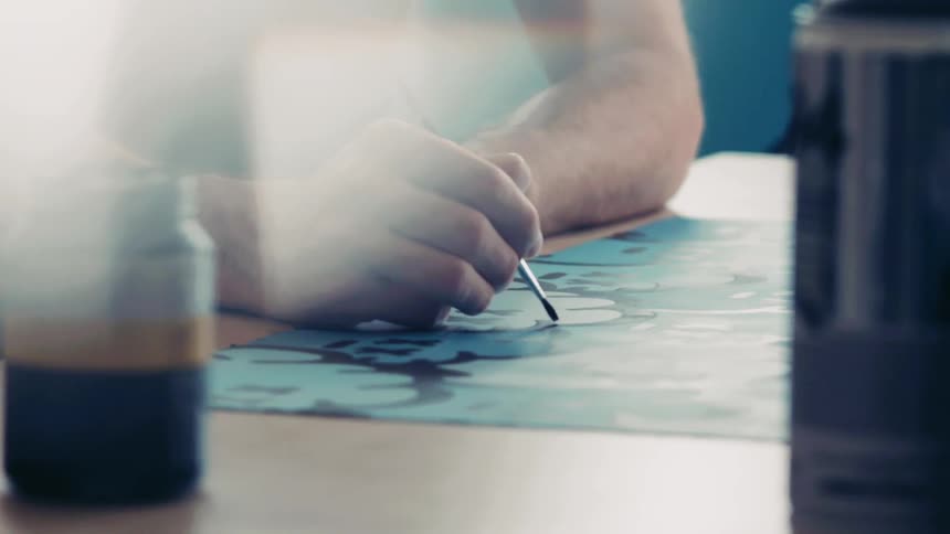A painter sits and paints