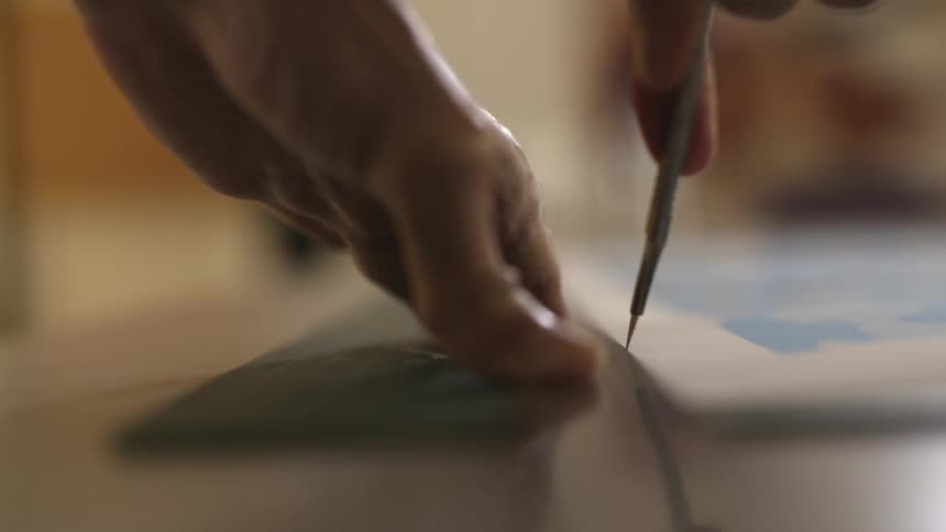A man cutting something with a blade