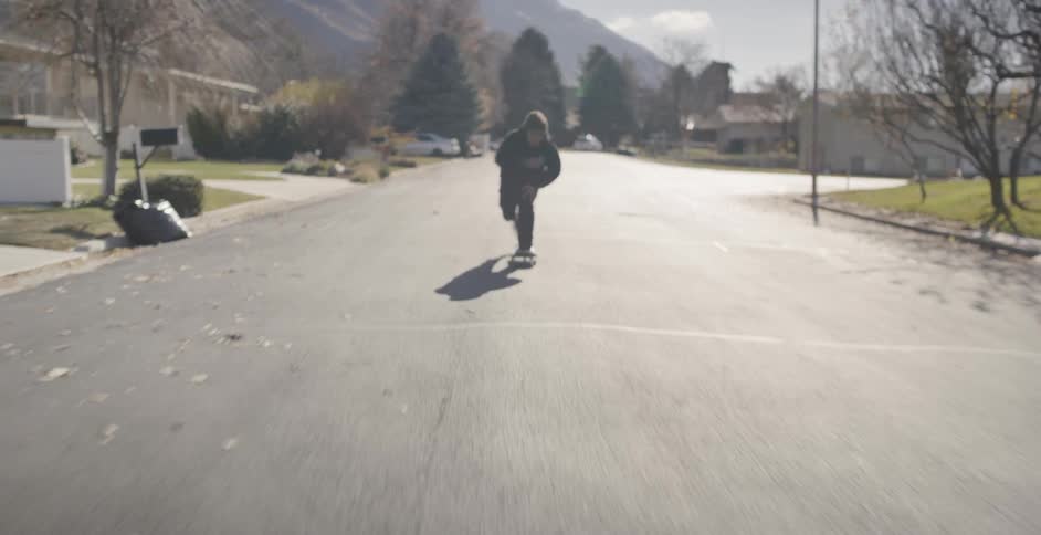 Man Skateboarding Around City