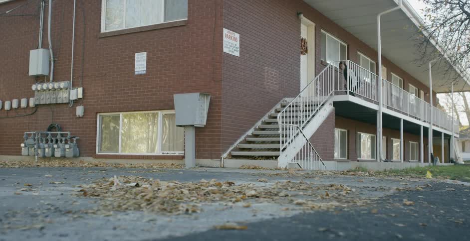 A person riding a skateboard down a railing