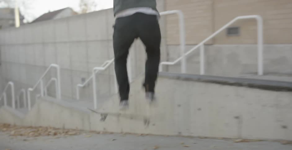 Skateboarder attempting a grind and almost falling in a wash