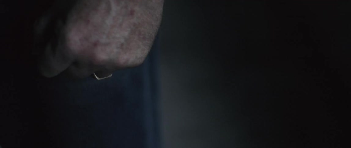 A person clenches his fist