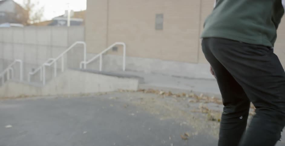 Man Skateboarding Around City