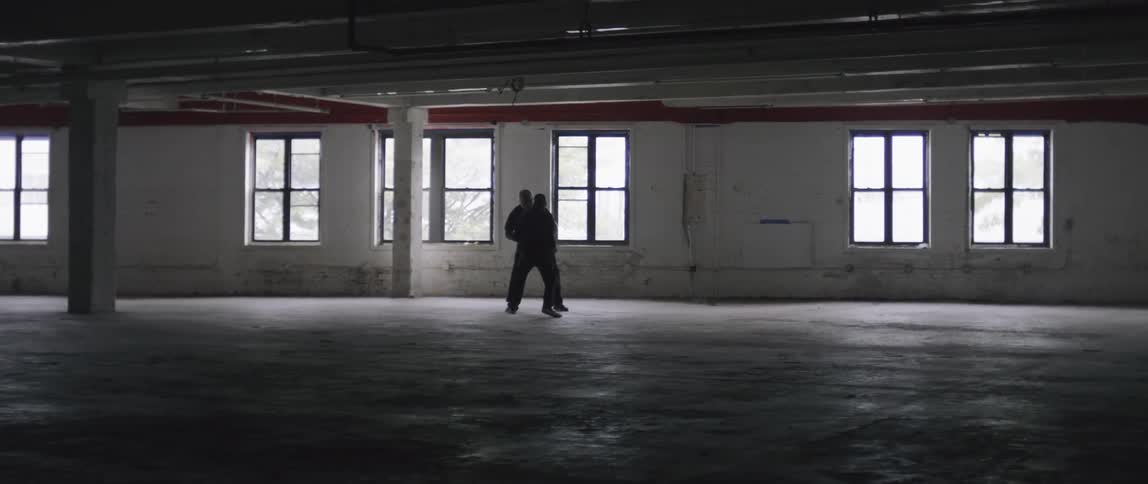Two men have a fist fight in the hall