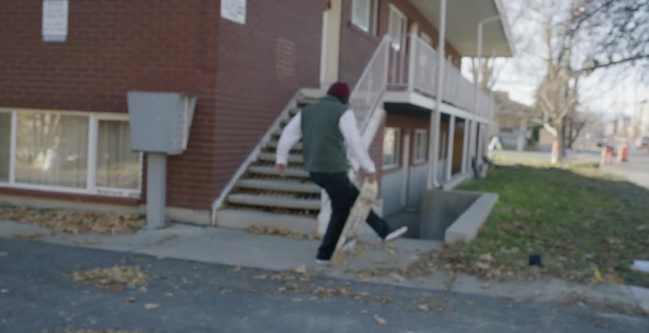 Man Skateboarding Around City