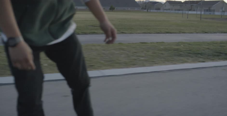 Man Skateboarding Around City